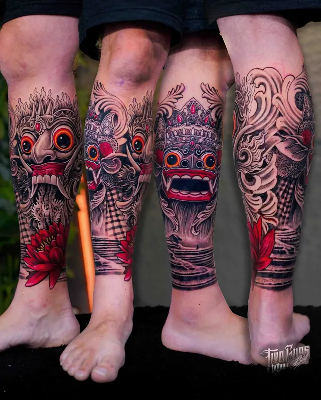 Black and grey Barong mask lower leg tattoos with red lotus accents, poleng cloth and rice terraces