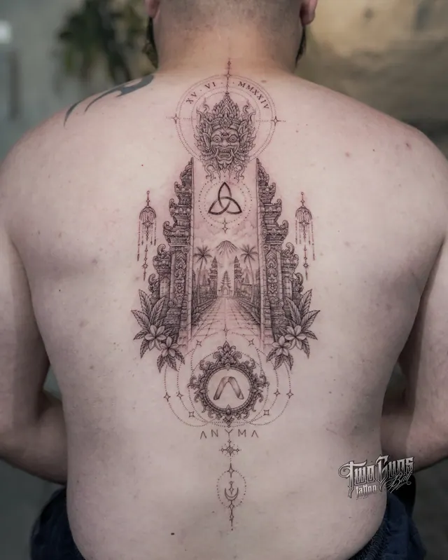 Fine line Balinese temple gate tattoo down a man's spine with a Barong face and Mount Agung
