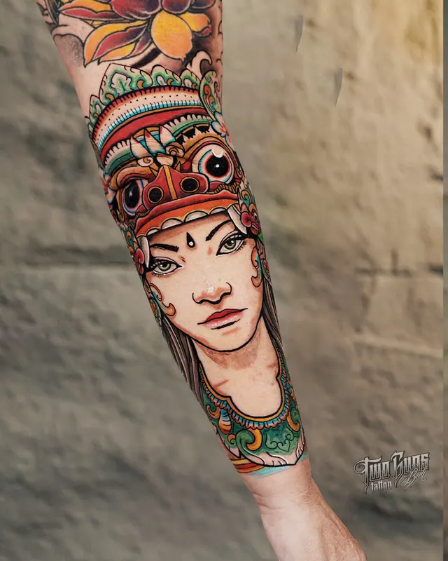 Colour neo-traditional forearm tattoo of a Balinese dancer in a traditional gelungan headdress