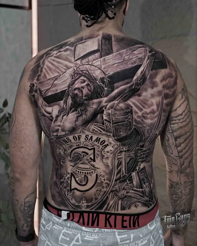 Black and grey realism full back tattoo of Jesus on the cross with a compass