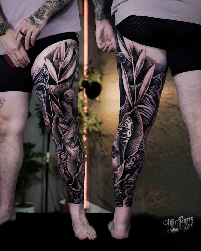 Black and grey ornamental and floral leg sleeve tattoos on both legs