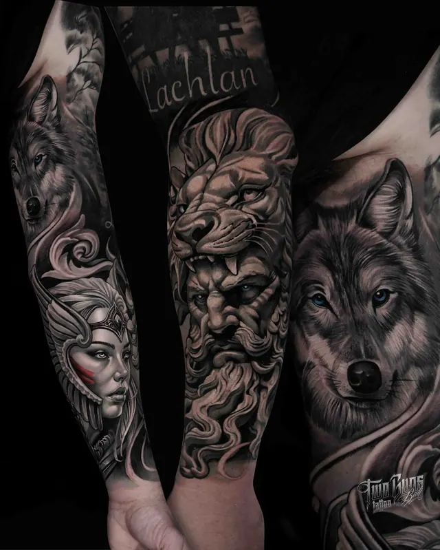 Black and grey realism arm sleeve tattoo of a lion, a woman's face and a wolf with lettering