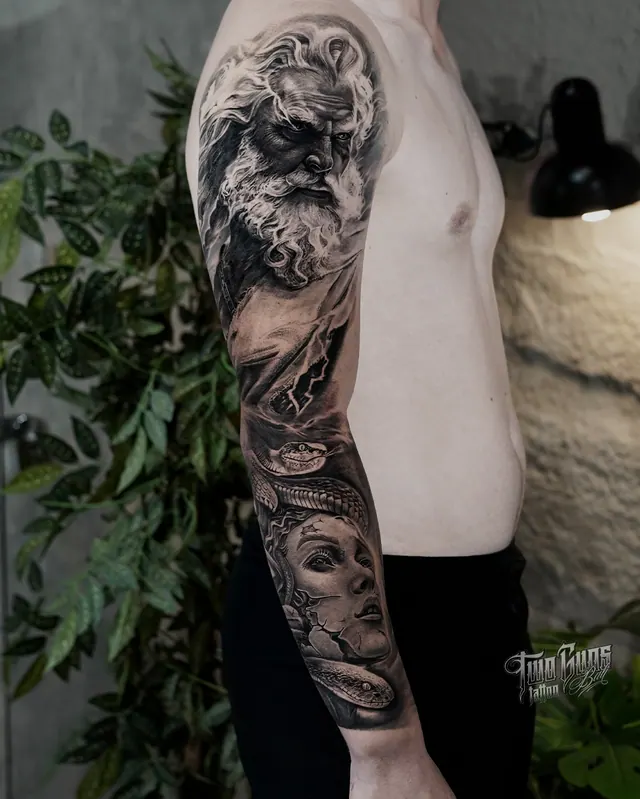 Black and grey realism full sleeve tattoo of a Greek god statue and a woman's face