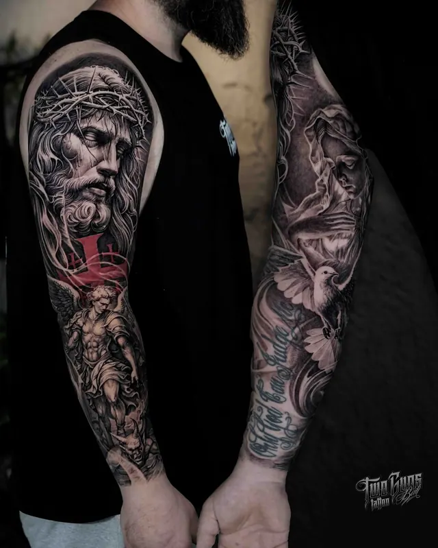Black and grey arm sleeve tattoos of religious statues with a red accent