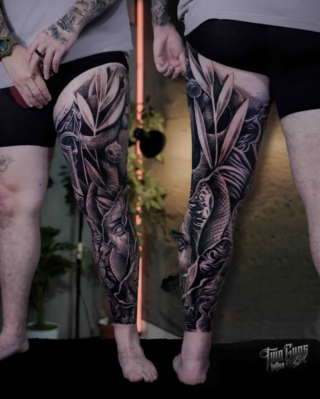 Black and grey leg sleeve tattoos with roses and snakes on both legs