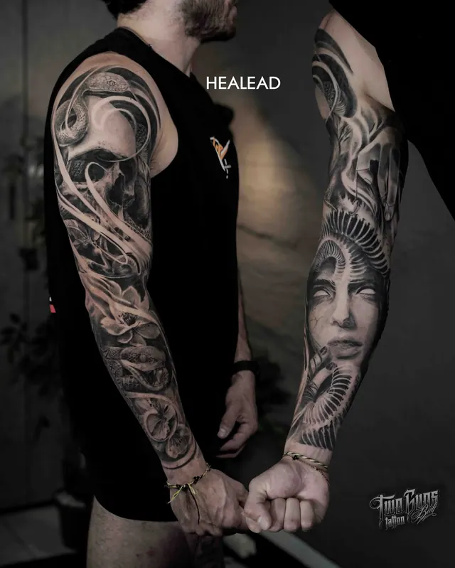 Black and grey realism full arm sleeve tattoo of a woman's face, shown healed