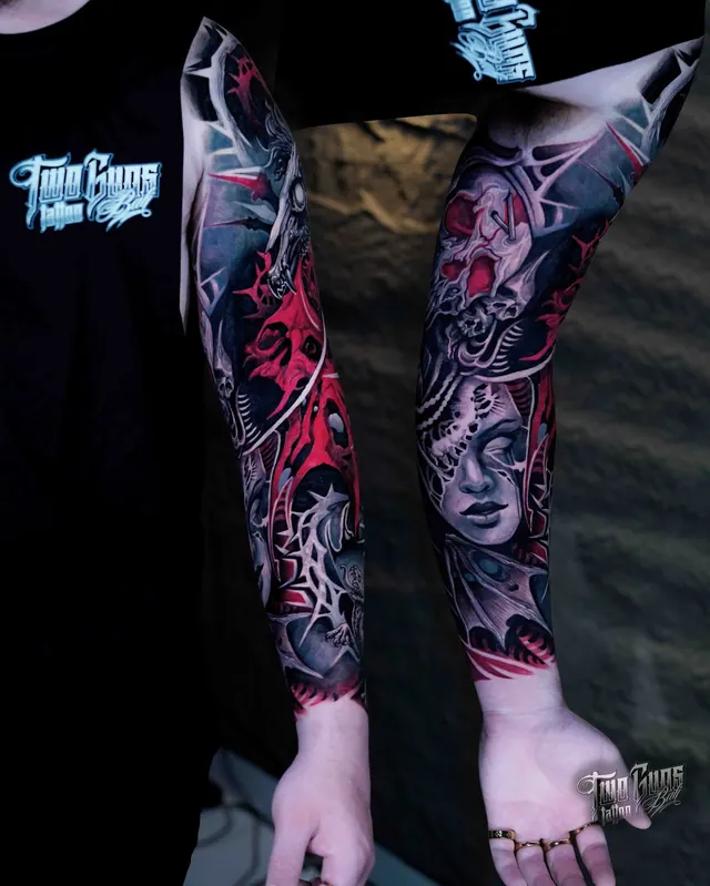 Black and grey forearm sleeve tattoos of women's faces with red accents