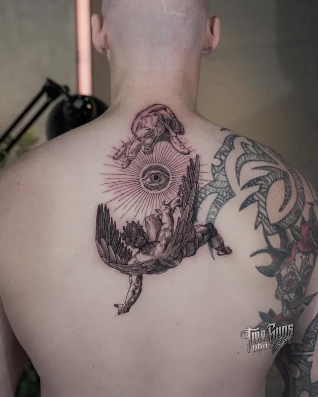 Fine line upper back tattoo of two winged figures and an all-seeing eye with radiating light