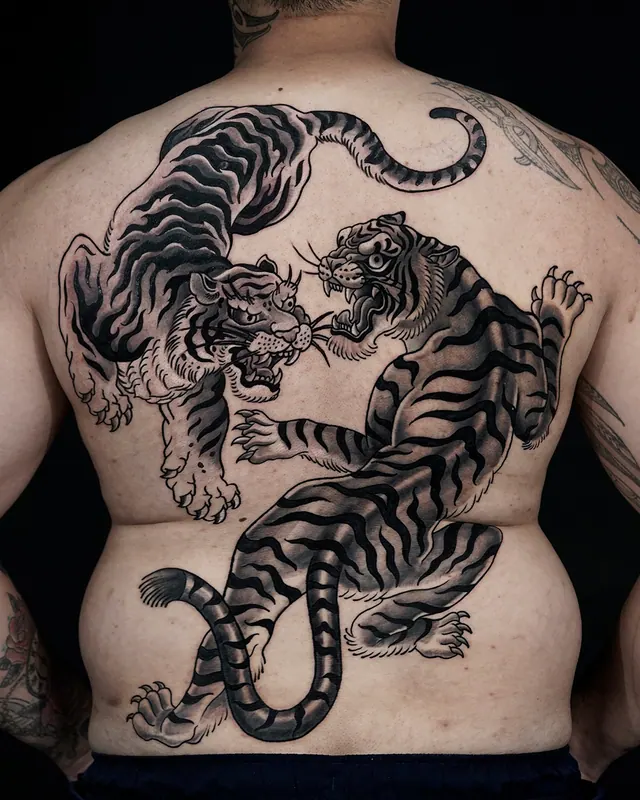 Traditional Japanese full back tattoo of a tiger and snake in black and grey