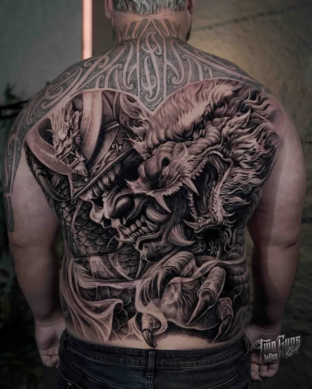 Black and grey Japanese full back tattoo of a hannya mask and dragon