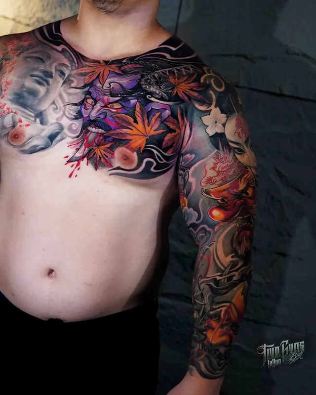 Japanese chest panel and sleeve tattoo with maple leaves and a hannya mask