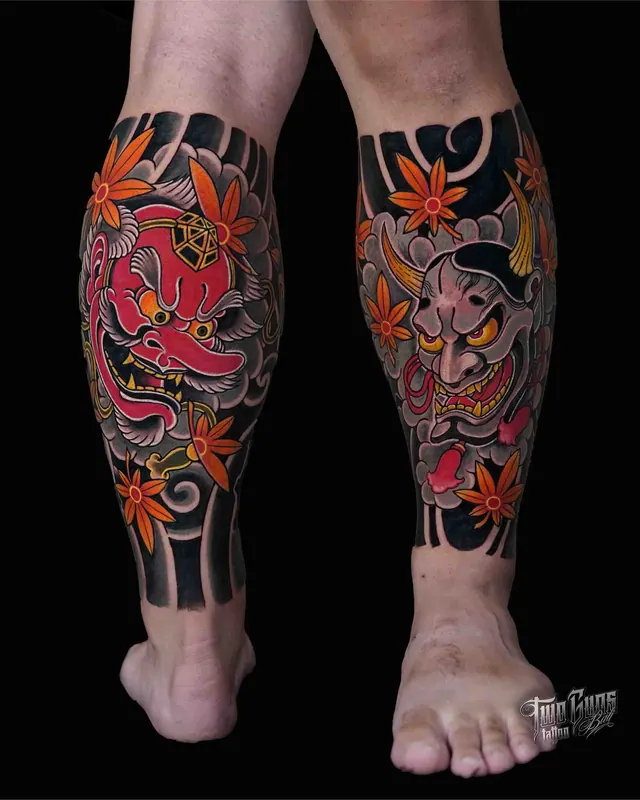 Traditional Japanese lower leg tattoos with shisa lion dogs and orange maple leaves