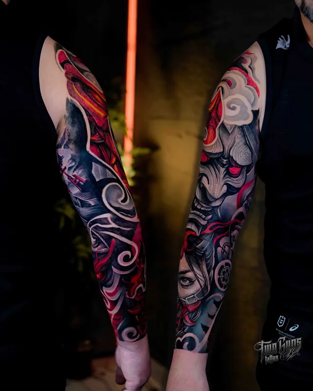 Neo-Japanese forearm sleeve tattoos in red and grey with a hannya mask, both arms