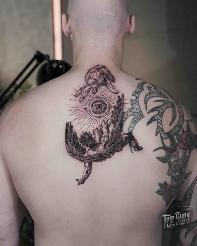 Fine line back tattoo of a winged eye above a landscape
