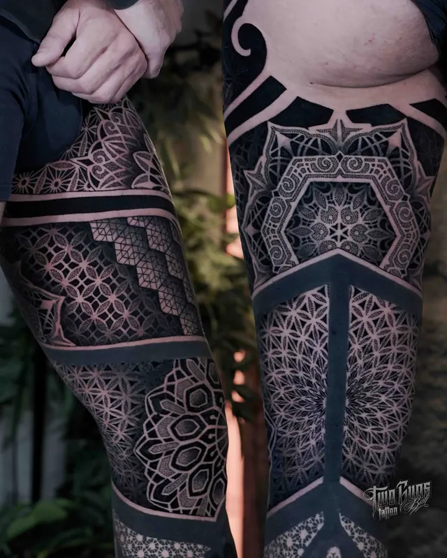 Blackwork sacred geometry leg sleeve tattoos with solid black panels