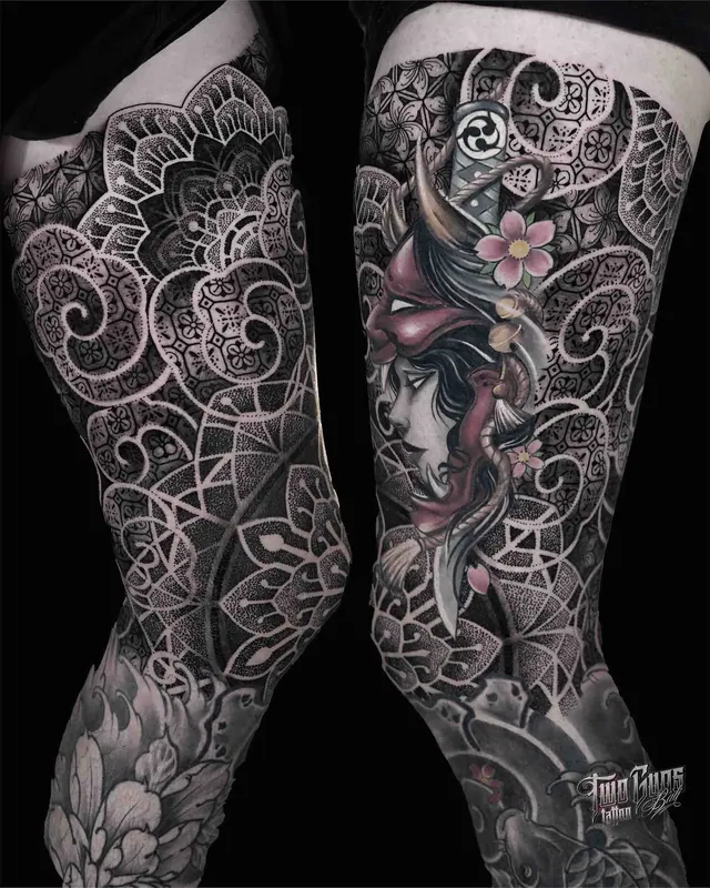 Ornamental dotwork thigh tattoos with a Japanese mask and flowers