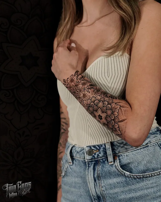 Fine line ornamental mandala forearm sleeve tattoo on a woman