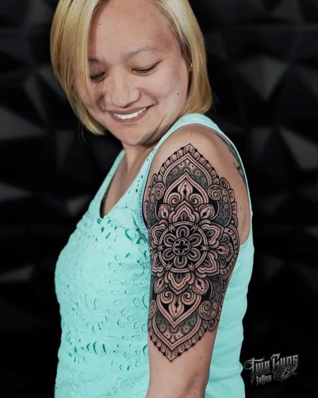 Dotwork mandala half sleeve tattoo on a woman's upper arm