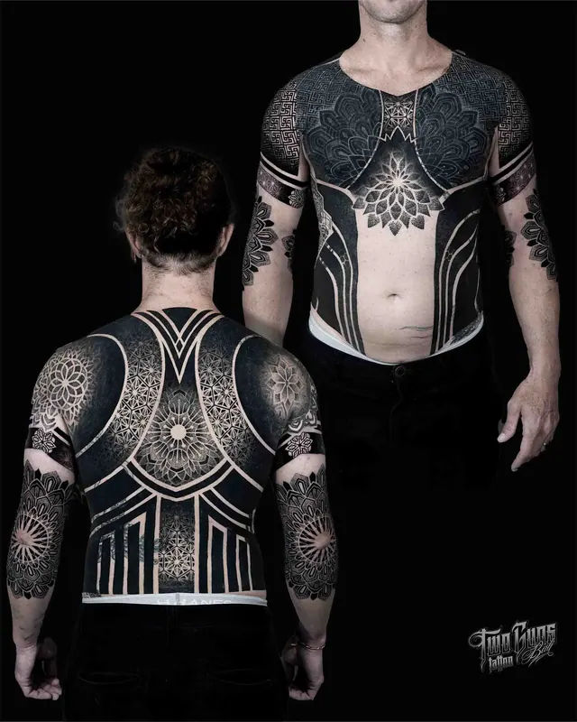 Blackwork sacred geometry chest and back tattoo in an armour panel layout
