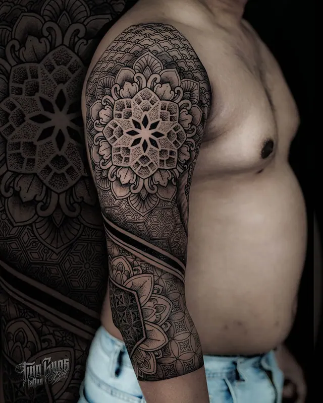 Dotwork mandala half sleeve tattoo on the upper arm