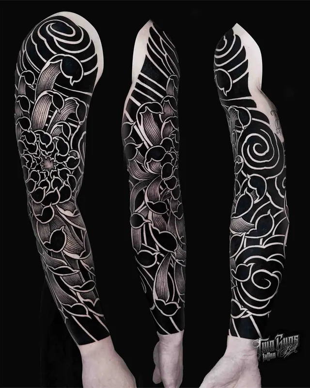 Blackwork full sleeve tattoo with negative space florals, shown from three angles