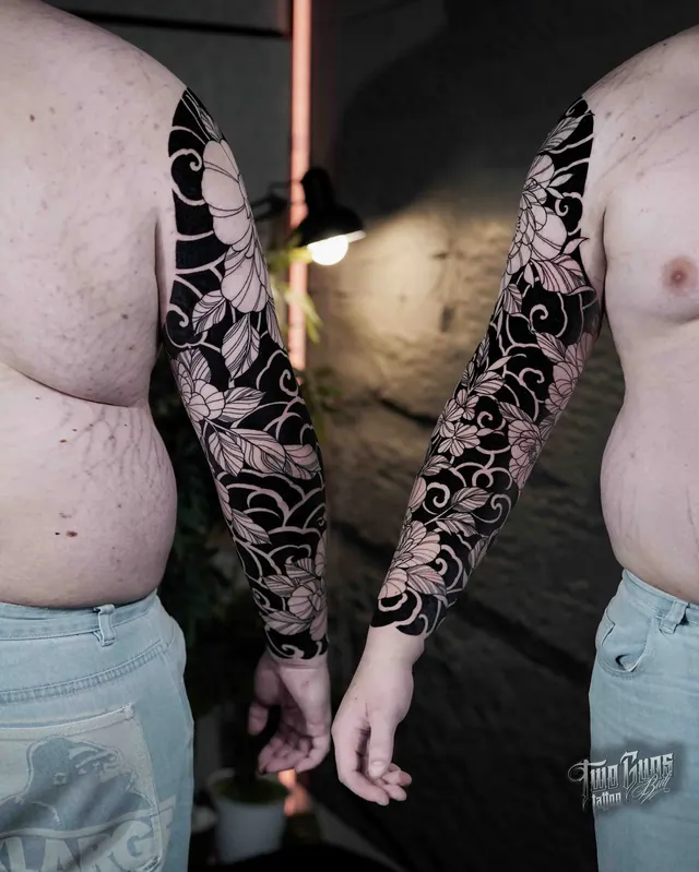 Blackwork floral full sleeve tattoos shown on two clients