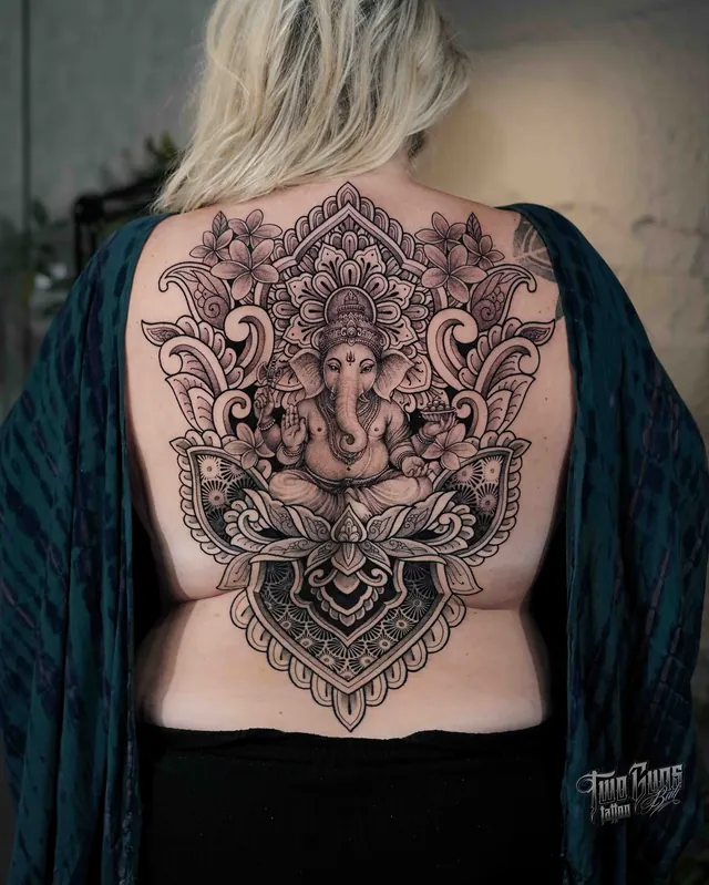 Ornamental full back tattoo of Ganesha within a mandala and lotus