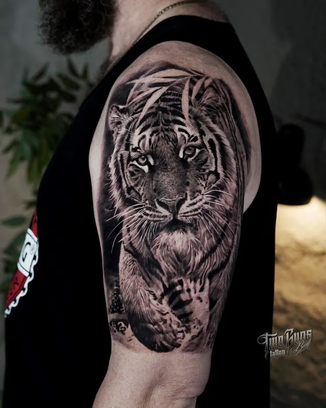 Black and grey realism tiger tattoo on the upper arm