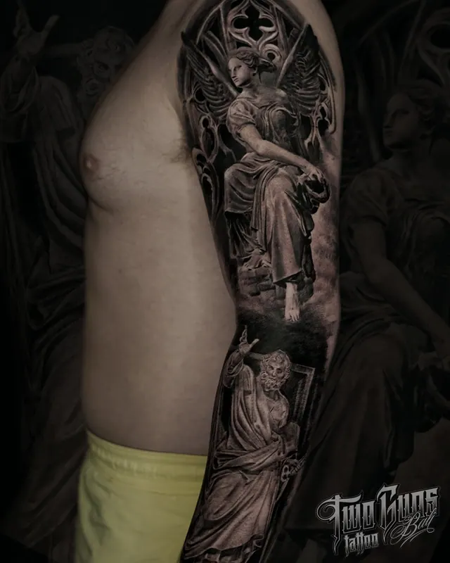Black and grey realism arm sleeve tattoo of religious statues and angels