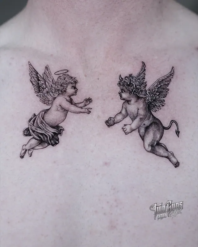 Two cherub tattoos reaching toward each other across the upper back