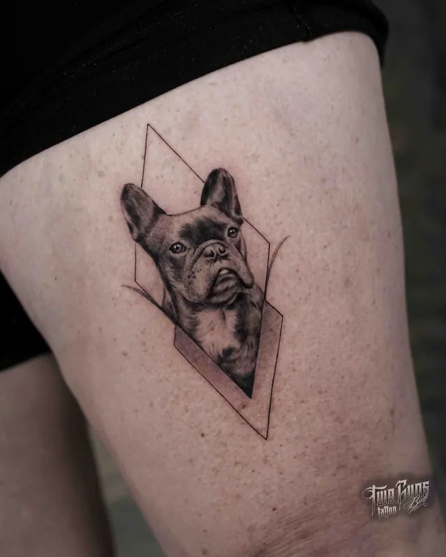 Fine line French bulldog portrait tattoo in a geometric frame, on the thigh