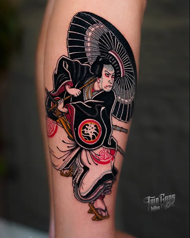 Colour ukiyo-e style tattoo of a samurai with a fan, on the calf