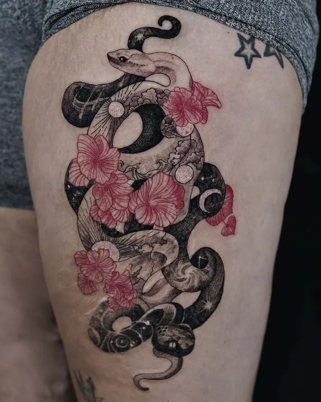 Black and grey snake thigh tattoo with pink cherry blossoms