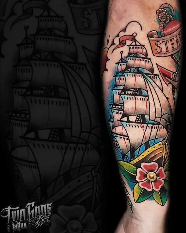 Colour traditional forearm tattoo of a tall ship with a banner and flower