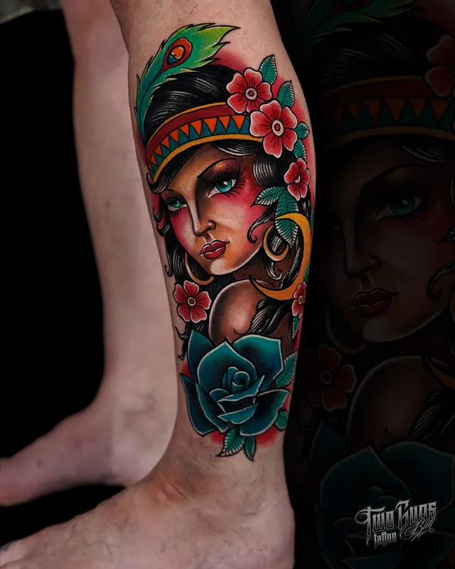 Neo-traditional colour calf tattoo of a woman in a headscarf with red flowers and a teal rose