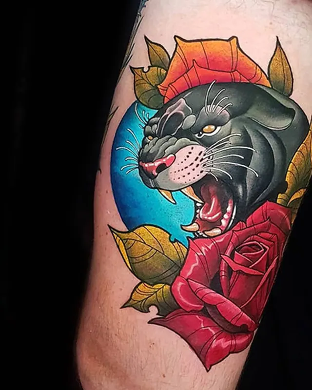 Neo-traditional thigh tattoo of a black panther head with a red rose